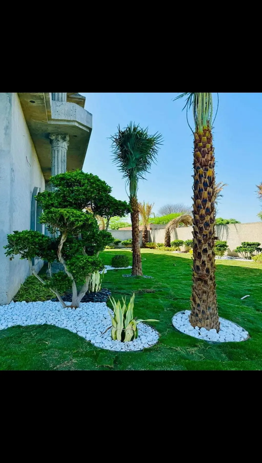 Formal garden with a central lawn and flower beds